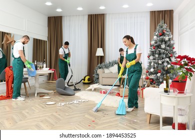 Cleaning Service Team Working In Messy Room After New Year Party