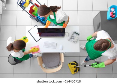 Cleaning Service Team Working In Office