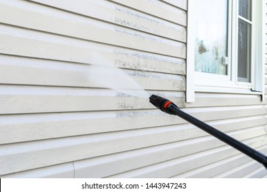Cleaning service washing building facade with pressure water. Cleaning dirty wall with high pressure water jet. Power washing the wall. Cleaning the facade of the house. Before and after washing