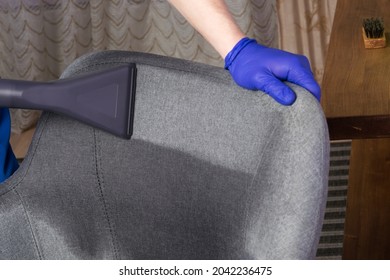 Cleaning Service Worker Cleans The Back Of An Office Chair, Close-up