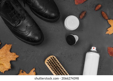 Cleaning Shoes. Shoe Brush, Shoe Polish And Water Repellent Shoe Spray. Rain Protection. Boots With Autumn Leaves On Black Stone Background.