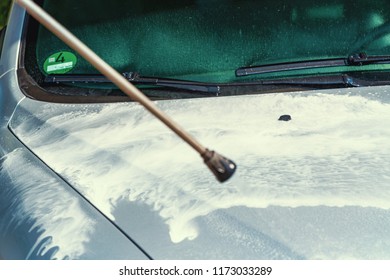 Cleaning Silver Cars Bonnet At Car Wash By Steam Radiator With Lots Of Foam.