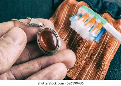 Cleaning Silver Jewellery With And Toothbrush And Baking Soda