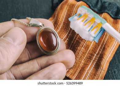 Cleaning Silver Jewellery With And Toothbrush And Baking Soda