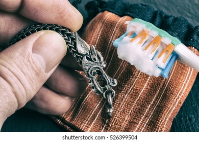 Cleaning Silver Jewellery With And Toothbrush And Baking Soda