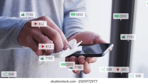 Cleaning smartphone screen, social media notifications image over hands. Technology, touchscreen, digital, communication, sanitizing, hygiene - Powered by Shutterstock