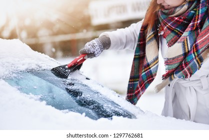 Cleaning snow from windshield, Scraping frozen ice, Winter car front windows clean. - Shutterstock ID 1297762681