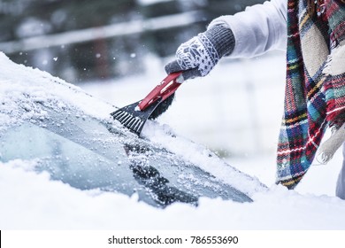 Cleaning snow from windshield, Scraping ice,  Winter car window cleaning - Shutterstock ID 786553690