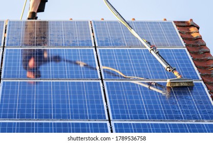 Cleaning Solar Panels With Brush And Water
