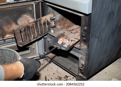 Cleaning The Solid Fuel Boiler From The Remains Of Firewood And Coal. Boiler With An Open Damper. Heating Efficiency In The House.