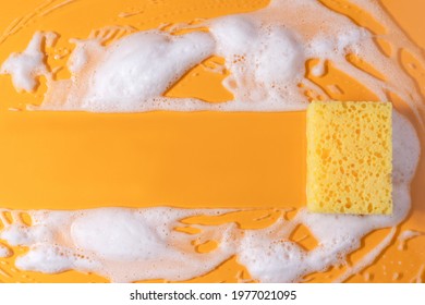 Cleaning sponge with soap. Texture with bubble suds on yellow background. copy space. Housekeeping cleaning with sponge. - Powered by Shutterstock