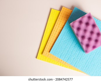 Cleaning sponges and rags on purple background