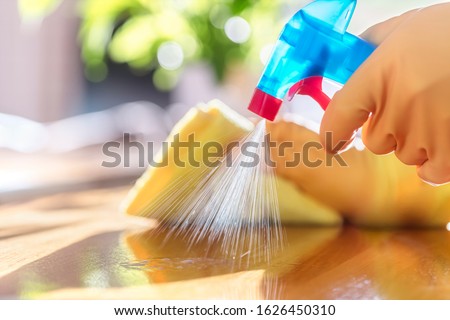 Cleaning with spray detergent, rubber gloves and dish cloth on work surface concept for hygiene