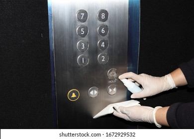 Cleaning Staff Cleaned Elevator Switch Button In Hospital With Alcohol Spray And Wipe Out With Clean Paper. Corona Virus Or Bacteria Infected Protection From Touch Public Object. 