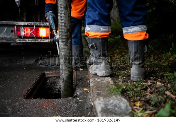 Cleaning storm drains from debris,\
clogged drainage systems are cleaned with a pump and\
water