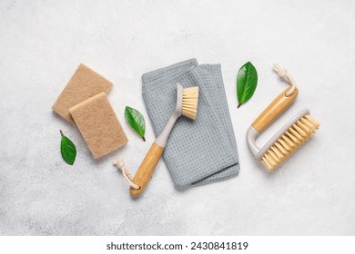 Cleaning supplies on a light background with copy space. Brushes and rags, gentle eco-cleaning - Powered by Shutterstock