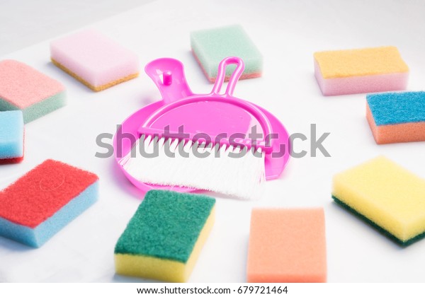 Cleaning supplies and products isolated on white\
background. Close up broom and dust pan on product cleaner\
background  Cleaning\
concept.