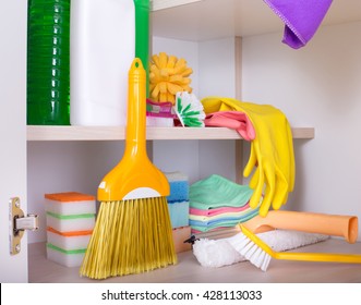 Cleaning Supplies And Tools Arranged On Shelves In Storage Place