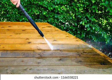 Cleaning Terrace With A Power Washer - High Water Pressure Cleaner On Wooden Terrace Surface