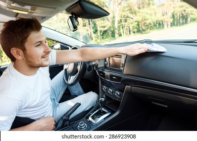 Cleaning Time. Portrait Of Young Handsome Man With Beard Sitting Inside Car And Wiping Dust 