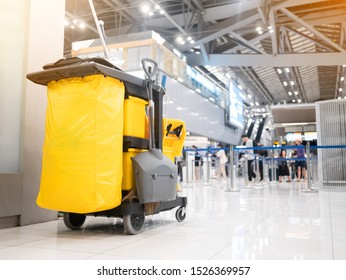 Cleaning tools cart cleaner in the airport. Bucket and set of cleaning equipment in the terminal airport. Concept of service clean.