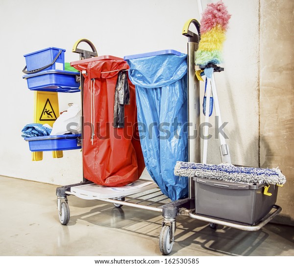 cleaning trolley\
(service cart) in front of\
wall