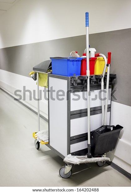 cleaning trolley\
(service cart) in front of\
wall
