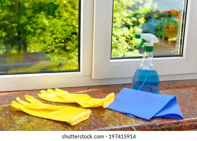 cleaning vinyl plastic window on a background of green trees