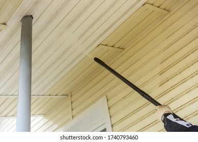 Cleaning The Vinyl Siding Wall With A High-pressure Washer.