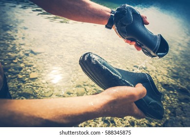 Cleaning Wet Shoes After Kayaking. Closeup Photo. Water Sports Accessories.