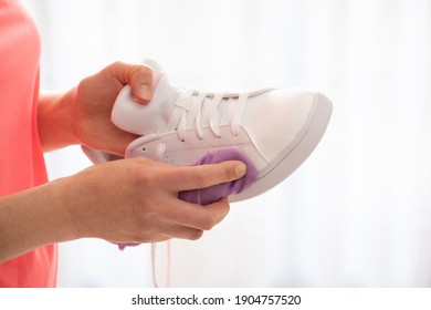 Cleaning White Sneaker With Purple Cloth