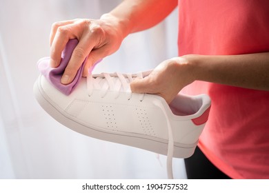 Cleaning White Sneaker With Purple Cloth