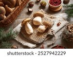 Cleaning wild king bolete or porcini mushrooms on a wooden table in autumn - preparation for drying