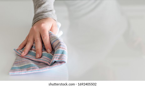 Cleaning Wipe With A Cloth In The Hands Of Woman Kitchen Table.  Housekeeping Service. The Concept Of Disinfection. Protection From Viruses And Bacteria