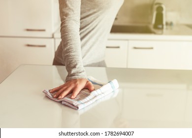 Cleaning Wipe With A Cloth In The Hands Of Woman Kitchen Table.  Housekeeping Service. The Concept Of Disinfection. Protection From Viruses And Bacteria 