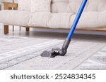 Cleaning with wireless handheld vacuum cleaner indoors, closeup