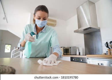 Cleaning Woman Working With Protection Mask And Gloves