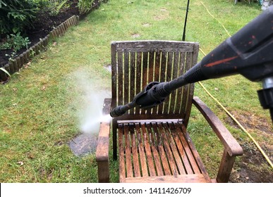 Cleaning Wood Furniture  With Jet Washer In A Garden