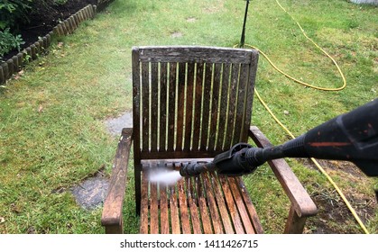 Cleaning Wood Furniture  With Jet Washer In A Garden