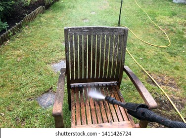 Cleaning Wood Furniture  With Jet Washer In A Garden