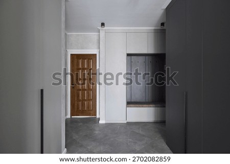 Cleanlined hallway with practical storage solutions and subtle lighting