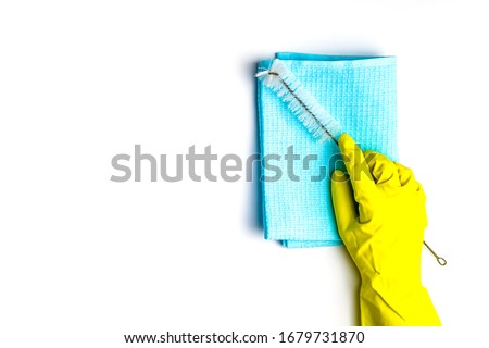 cleanliness and cleaning. rag, sponge and ruff. females hand in yellow gloves