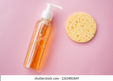 Cleansing Oil For The Face Or Cleansing Gel With Oils. Skin Cleaning, Makeup Removal, Facial Cleanser, Washing, Pink Background. Selective Focus