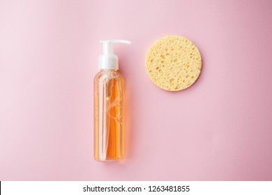 Cleansing Oil For The Face Or Cleansing Gel With Oils. Skin Cleaning, Makeup Removal, Facial Cleanser, Washing, Pink Background. Selective Focus