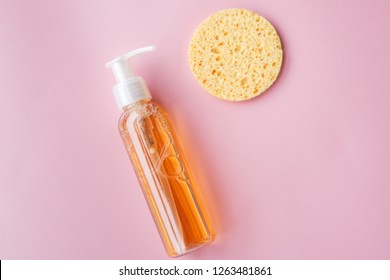 Cleansing Oil For The Face Or Cleansing Gel With Oils. Skin Cleaning, Makeup Removal, Facial Cleanser, Washing, Pink Background. Selective Focus