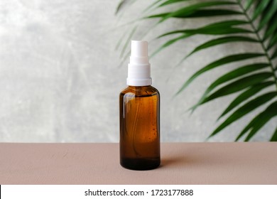 Clear Amber Glass Spray Bottle Mockup With Tropical Green Leaf. Natural Organic Cosmetic Or Herbal Medicine Product. Minimal Style Brand Packaging Mockup. Healthcare Concept