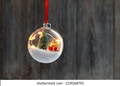 Clear Ball Ornament  with christmas tree,  small gift and christmas light inside. - Powered by Shutterstock