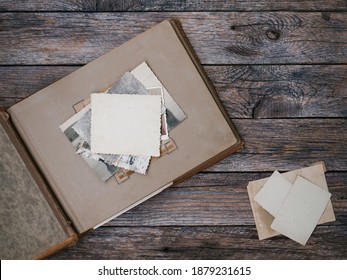 Clear Blank Photo Frames To Placed Your Pictures Or Text On Old Family Album On Wooden Board Background In Retro Style. Family Traditions, Memories And Nostalgia Concept. Antique Album With Old Photos