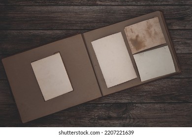 Clear Blank Photo Frames To Placed Your Pictures Or Text On Old Family Album On Wooden Background In Retro Style. Family Traditions, Memories And Nostalgia Concept. Antique Album With Old Photos.