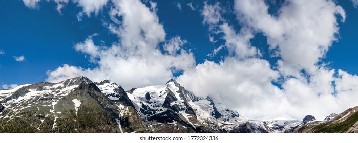 clear blue panorama in the austrian alps with clouds and a spectacular view at the Grossglockner